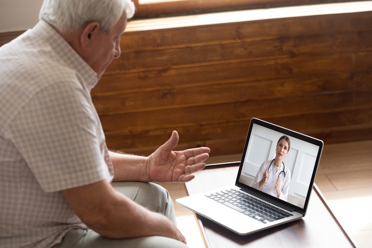 How telemedicine works - older patient meeting with doctor via laptop and video call